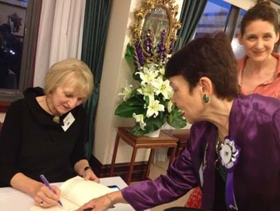 Helen Trinca signs a book for Jenny Strachan